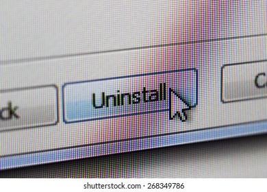 The mouse cursor presses the button uninstall, photograph of a computer monitor, 