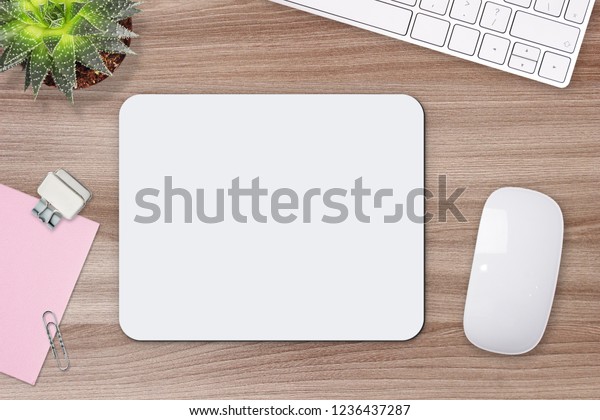 Mouse pad\
mockup. White mat on the table with\
props.
