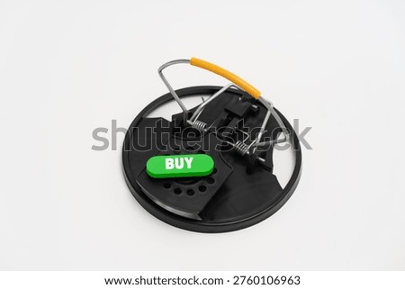 Mouse trap with buy button symbolizing impulsive purchase, consumer risk and marketing trap leading to financial loss.