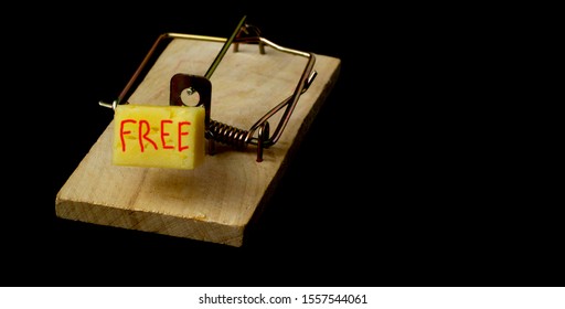 mousetrap with free cheese on black background. trap for gullible people. concept. freebie