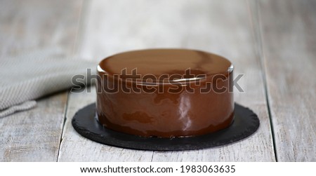 The mousse cake is decorated with chocolate mirror glaze. Modern dessert