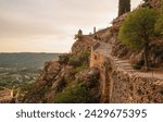 Moustiers-Sainte-Marie panoramic view of stone staircase on the hillside way to the Chapelle Notre-Dame de Beauvoir overlooking the medieval village,  France.