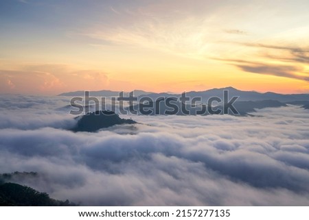 Moutain sunrise with the fog foreground