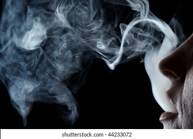 Mouth Exhaling Cigarette Smoke On Black Background