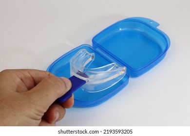 A Mouth Guard, Anti Snoring, With Its Blue Handle