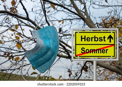 Mouth mask and street sign saying "sommer und herbst", translation "summer and autumn" - Shutterstock ID 2202059323