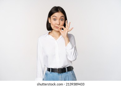 Mouth Shut. Young Asian Woman Seal Lips, Showing Taboo Dont Speak, Keep Quiet Sign, Hiding Secret, Standing Over White Background