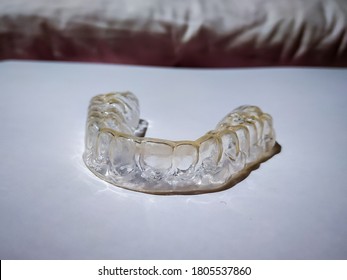 Mouthguard - A Plastic Shield Held In The Mouth To Protect The Teeth And Gums. Worn During Sleep