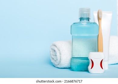 Mouthwash and other oral hygiene products on colored table top view with copy space. Flat lay. Dental hygiene. Oral care products and space for text on light background. concept. - Shutterstock ID 2166876717