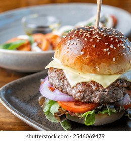 A mouthwatering cheeseburger featuring a juicy beef patty, fresh lettuce, tomato, and melted cheese, served on a wooden table with colorful side salad. - Powered by Shutterstock