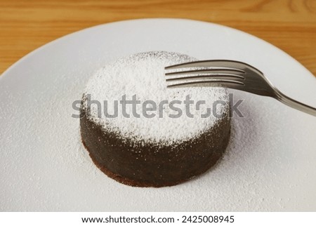 Mouthwatering Rich Chocolate Cake Sprinkled with Powdered Sugar