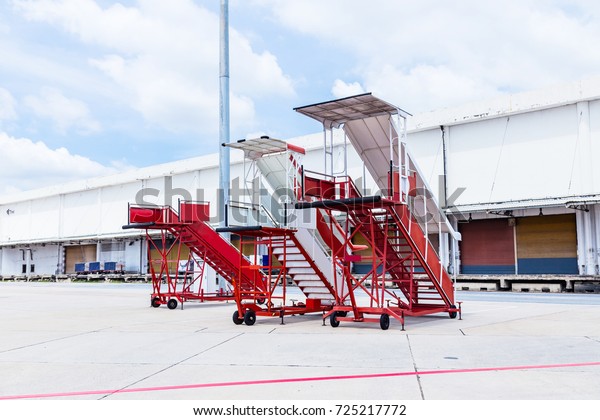 Movable boarding ramp Passenger\'s ladder over\
airport background