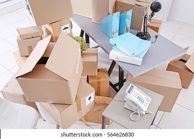 Move Concept. Unpacking Cardboard Boxes In A New Office