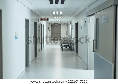 Moveable hospital bed in an empty hospital corridor, copy space. Hospital, medical and healthcare services.