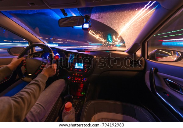 Movement of the\
car at night at a speed view from the interior, Brilliant road with\
lights with a car at high\
speed