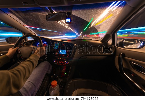 Movement of the\
car at night at a speed view from the interior, Brilliant road with\
lights with a car at high\
speed