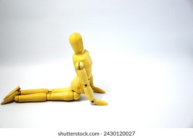 The movement postures in yoga asanas called bhujangasana which are demonstrated using a wooden mannequin photographed on the isolated white background - Powered by Shutterstock