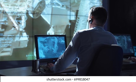 Movement Shot Back View Of Man Working On Space Mission In Control Center. Elements Of This Image Furnished By NASA.