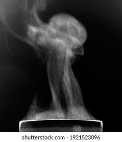 The movement of steam over the cup. Liquid evaporation. Black and white.