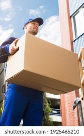 Mover Men Loading Delivery Van With Furniture And Packages