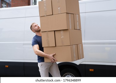 Movers Carrying Heavy Large Box Stack Near Truck - Powered by Shutterstock