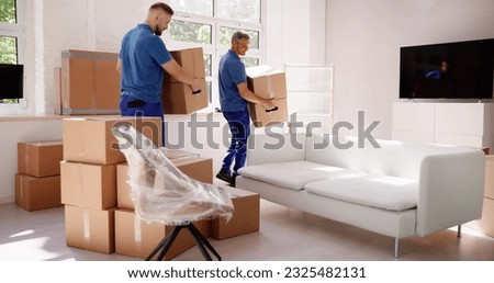 Movers Delivering Packaging Boxes. Moving And Relocation