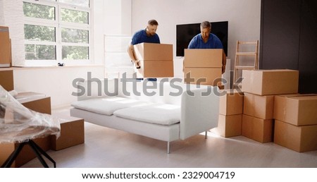 Movers Delivering Packaging Boxes. Moving And Relocation