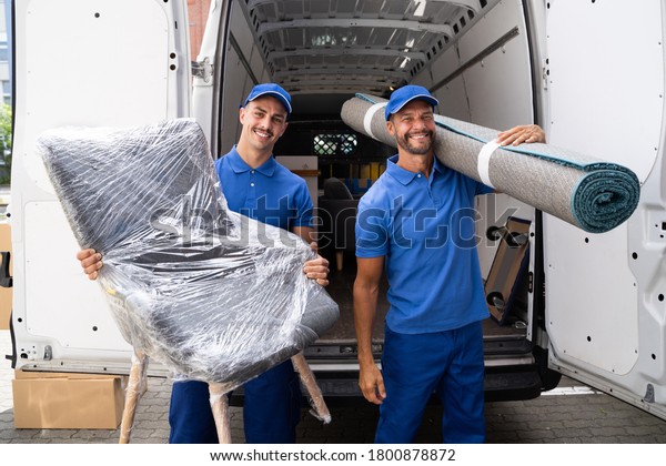 Movers Doing Furniture And Carpet Removal From Truck\
Or Van