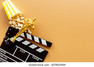 Movie Clapper Board With Golden Film Award Statue And Popcorn