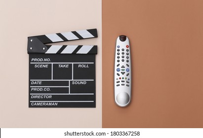 Movie Clapper Board With Tv Remote On Beige Brown Background. Filmmaking, Movie Production, Entertainment Industry. Top View