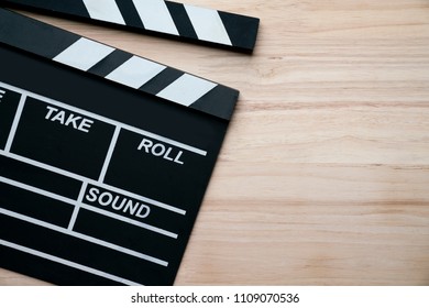 movie clapper on wood table ; film, cinema and video photography concept