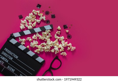 Movie Clapperboard, Confetti And Popcorn On A Pink Background. Online Cinema Concept, Movie Night. Flatlay.space Copy