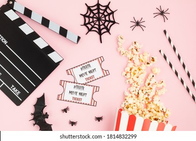 Movie Clapperboard And Halloween Decoration Over Pink Background. Horror Movie Night, Halloween Party Invitation. Top View, Copy Space, Mockup