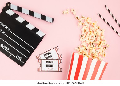 Movie Clapperboard, Tickets And Popcorn Over Pink Background. Movie Night, Home Cinema, Party Invitation. Top View, Copy Space, Mockup