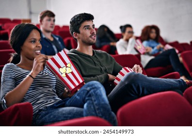 Movie, date and couple in cinema at night with popcorn to relax and watch in theatre with happiness. Film, experience and people in audience enjoy funny comedy, drama performance or eating snack food - Powered by Shutterstock