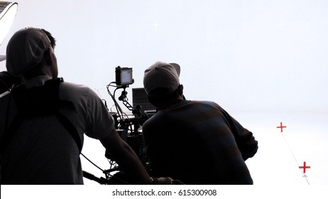 Movie director and photographer are talking or consulting to making studio set before shooting video production and silhouette background lighting. - Powered by Shutterstock