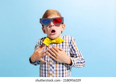 At Movie, Horror Film. Emotional Preschool Boy, Kid Wearing Retro Style Outfit And 3d Glasses Isolated On Light Blue Background. Concept Of Child Emotions, Facial Expression, Fashion And Ad.
