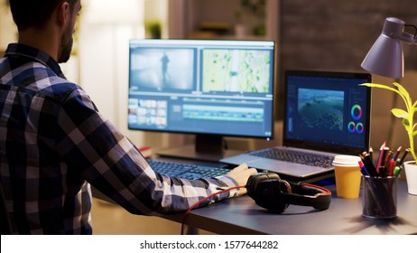 Movie maker editing a film using modern software for post production. Young videographer. Home office.
