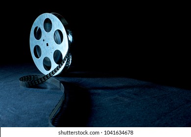 Movie reel on a black background with shadow