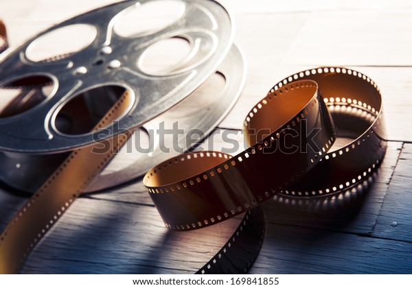 Movie reel on a wooden\
background