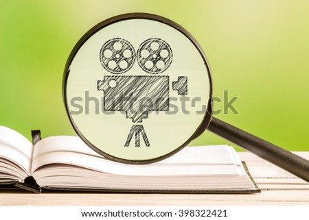 Movie search with a pencil drawing of a movie projector in a magnifying glass