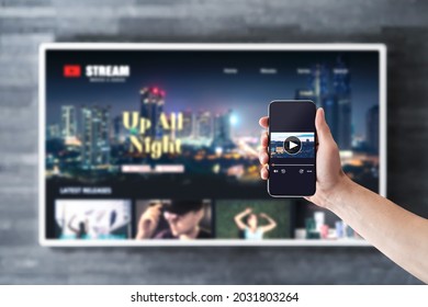 Movie stream with tv and phone. Watching on demand (VOD) series mockup with smart television and cellphone. Man using remote control video player app in smartphone. Streaming service subscription. - Shutterstock ID 2031803264