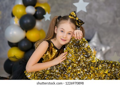 Movie Super Star Girl Model Posing In Studio Shoot With Golden Star And Colorful Baloons Wearing Stylish Gold Airy Dress With Shining Bow Tie.Super Star Pillow Deisigned By Photographer