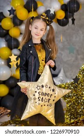 Movie Super Star Girl Model Posing In Studio Shoot With Golden Star And Colorful Baloons Wearing Stylish Gold Airy Dress With Shining Bow Tie.Super Star Pillow Deisigned By Photographer