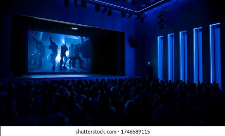 In Movie Theater Captivated Audience Watching New Blockbuster Film with Military Soldiers. - Powered by Shutterstock