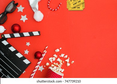 movie tickets, clapperboard, pop corn and 3d glasses in a red frame background..Flat lay .Christmas concept