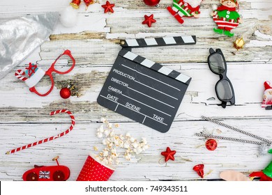 movie tickets, clapperboard, pop corn and 3d glasses in a rustic white wooden table background..Flat lay .Christmas concept