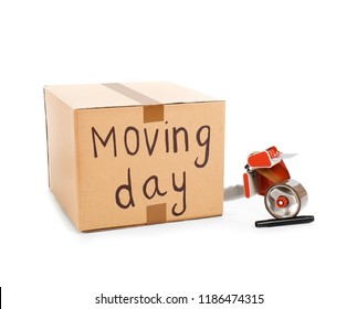 Moving box, marker and adhesive tape dispenser on white background - Shutterstock ID 1186474315