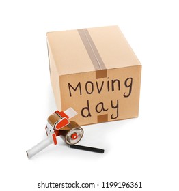 Moving box, marker and adhesive tape dispenser on white background - Shutterstock ID 1199196361
