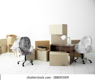 Moving Cardboard Boxes And Personal Belongings In Empty Office Space